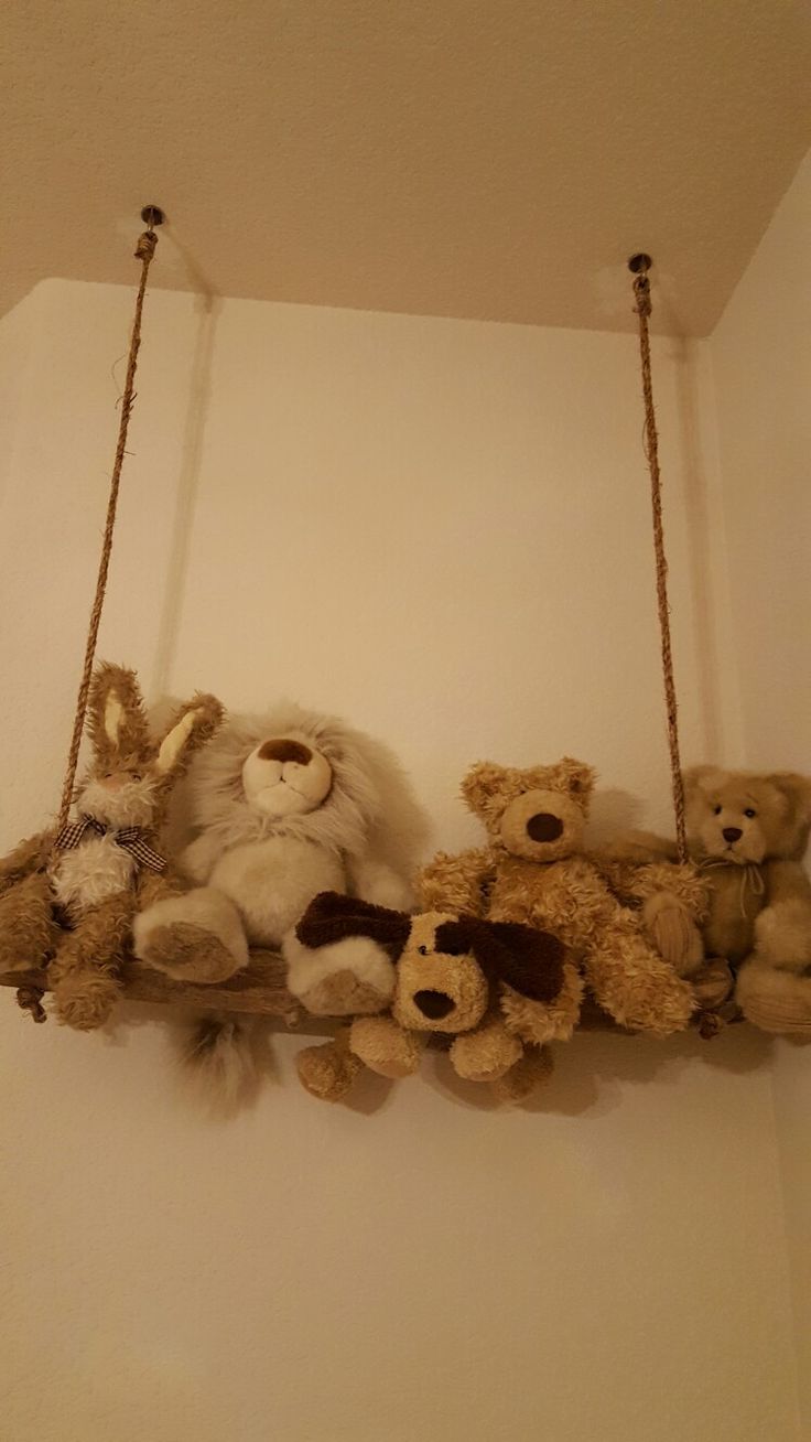 several stuffed animals are hanging from the ceiling