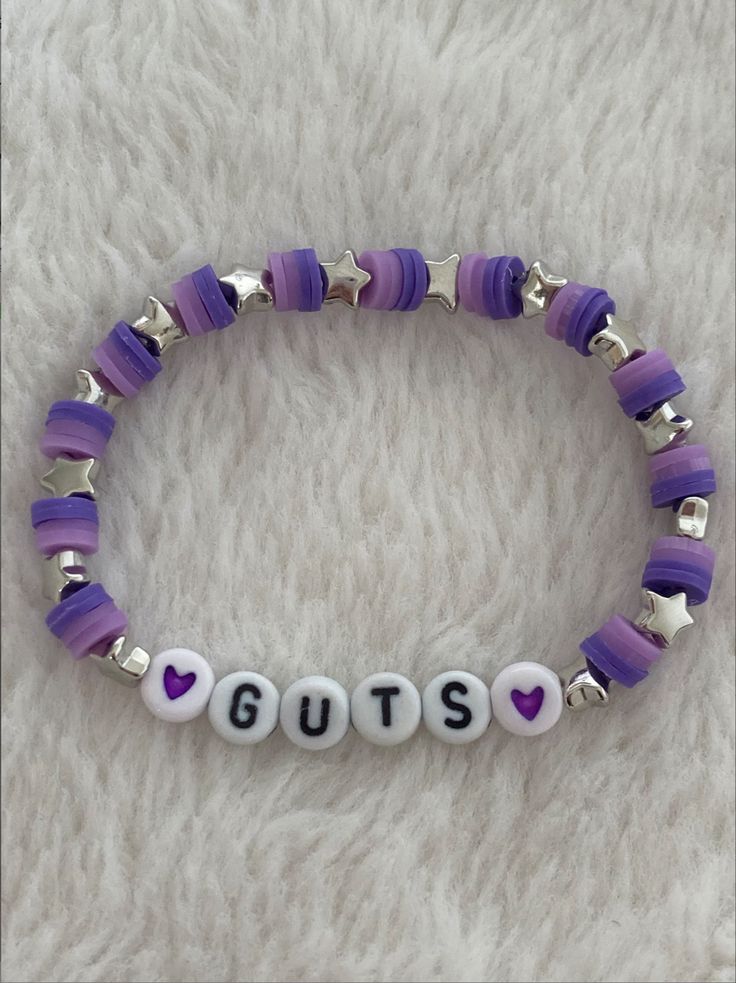 NOT MY PHOTO!! ❌ Guts Your Bracelets, Olivia Bracelet Ideas, Olivia Rodrigo Guts Tour Bracelets, Bracelet Small Beads, Themed Beaded Bracelets, Bracelets Inspo Beads, Clay Bead Bracelet Ideas Olivia Rodrigo, Bracelet Ideas Olivia Rodrigo, Oliva Rodrigo Bracelet