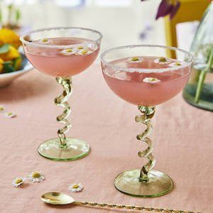 two glasses filled with pink liquid sitting on top of a table