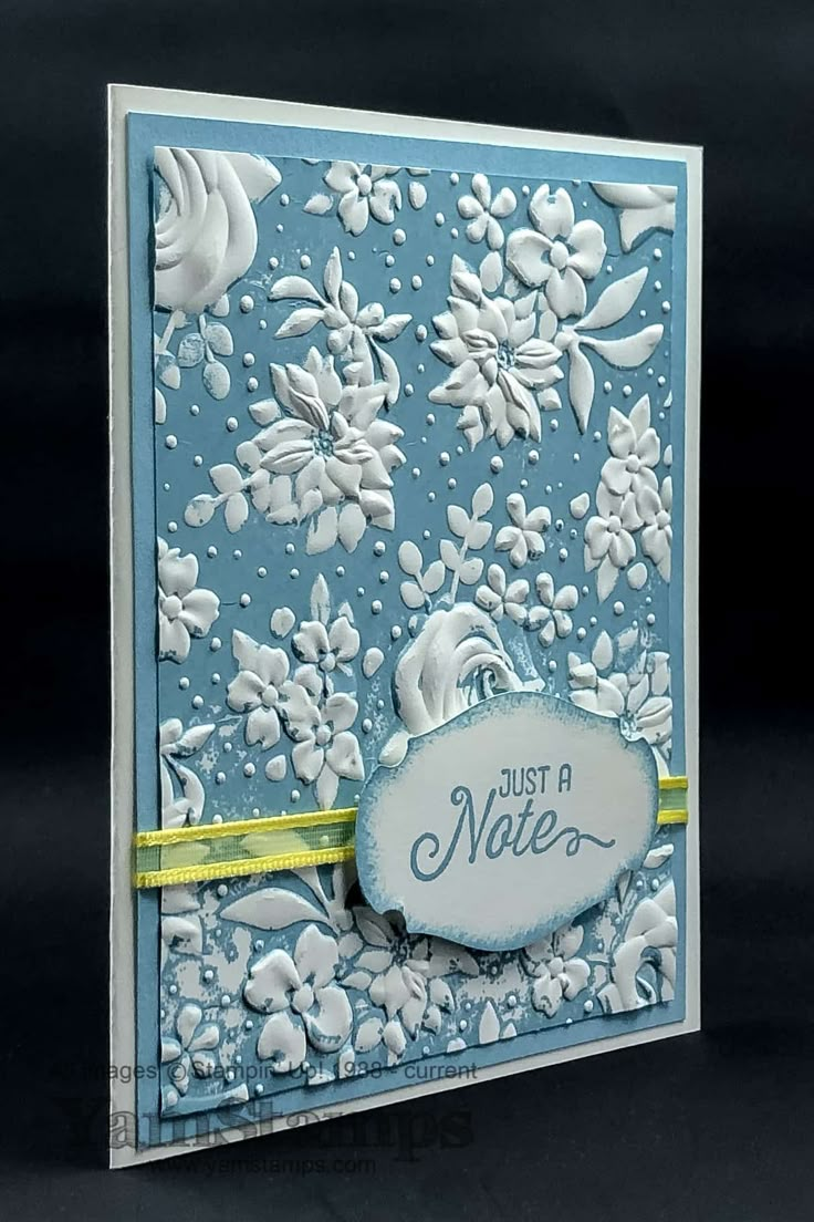 a blue and white greeting card with flowers on the front, says just a nite