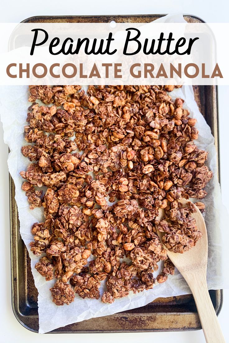 chocolate granola on a baking sheet with a wooden spoon in it and the words, peanut butter chocolate granola