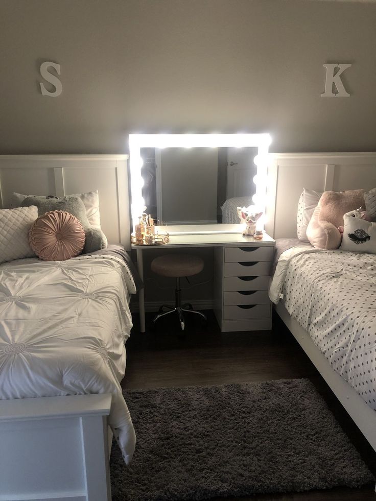 two beds with white sheets and pillows in a bedroom next to a desk, mirror and dresser