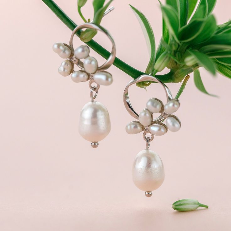 An elegant pair of floral pearl earrings features a baroque pearl dangle tear drop on dainty stud earrings, comes in gold or silver color. These elegant pearl drop earrings are perfect wedding jewelry gift, simple bridal earrings, or everyday earrings gift for your love one. Materials are solid 925 sterling silver with gold plate or platinum plate and pearls. *Pearls are natural so shape and size maybe vary a little bit. Jewelry Care: See more information about how to care for your jewelry here. Pear-shaped Pearl Drop Bridal Earrings In White Gold, Delicate Pearl Earrings With Pearl Pendant, Delicate Pearl Earrings With Pendant, Graceful Pearl Earrings With Pearl Charm, Delicate Dangle Pearl Earrings, Delicate Pearl Dangle Earrings, Graceful Pearl Dangle Earrings, Elegant Pearl Dangle Earrings, Elegant Silver Earrings With Pearl Chain