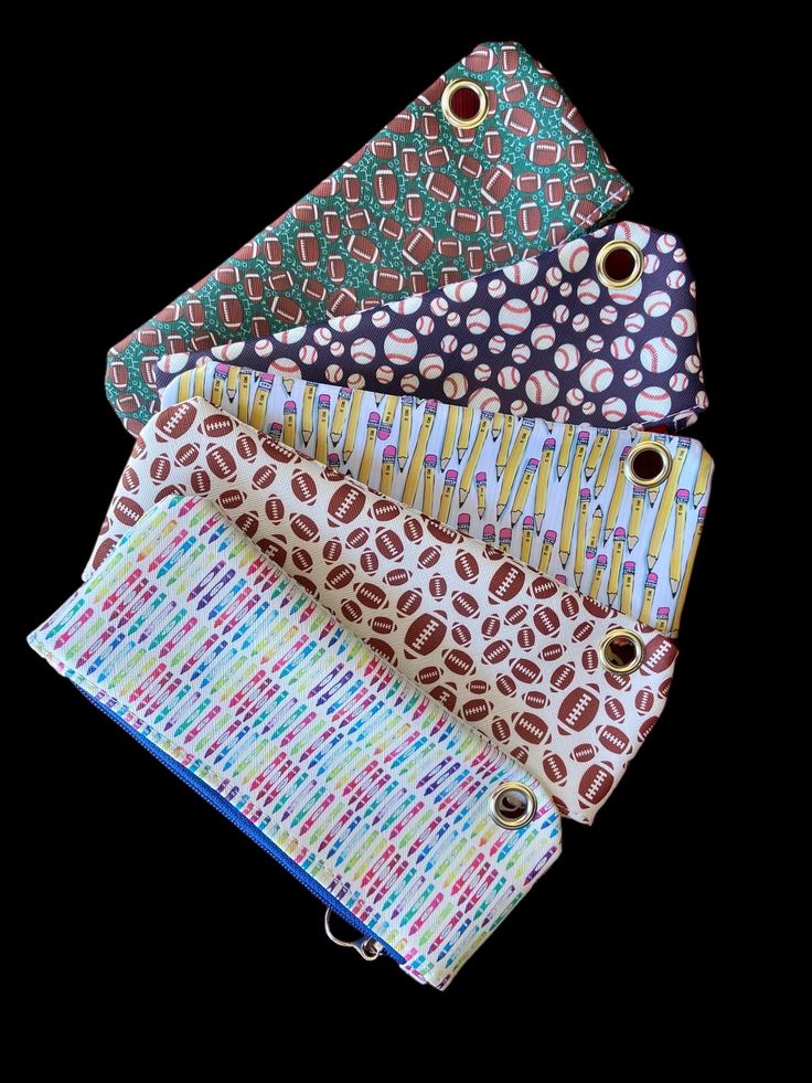 This handmade patterned faux leather pencil case is perfect as a back-to-school gift for organizing school supplies. Its durable faux leather exterior comes in fun, colorful patterns and has a convenient top-zippered closure. The case also features a silver grommet that allows it to be secured inside a 3-ring binder for easy access. This case is unlined. Features: **Versatile Use Holds pencils, and pens, and can be used as a gift card holder. **Durable Materials Made with faux leather, a nylon z Trendy Multicolor Pencil Case With Zipper, Fun Rectangular Pencil Case For Daily Use, Playful Pencil Case For Everyday Use, Back To School, Playful Bags With Pen Slots For Everyday Use, Multicolor Pencil Case For Daily Use, Playful Pencil Case For Back To School, Trendy Multicolor Pencil Case With Pen Holders, Playful Multicolor Pencil Case For Everyday Use, Playful Multicolor Pencil Case For Daily Use