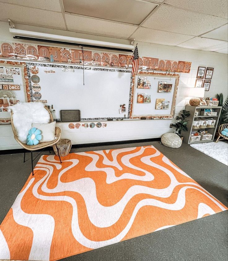 an orange and white area rug in front of a whiteboard with pictures on it