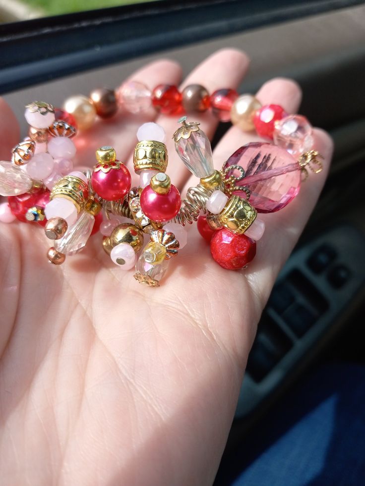 Enjoy this beautiful beaded bracelet anywhere!  It looks just as great with jeans  as it does with your favorite little black dress. The beads are a mix of crystal, glass, acrylic, gold primarily.  The color scheme is pinks and fuschia and a touch of red..   It's is approximately 7 inches in length but will adjust for nearly any size.  Stung on a strong stretch filament it is both durable and functional as well as beautiful! If you desire a special length, customization or adaptation just contact me before placing your order. I'll gladly see if I can accommodate your request, usually at no charge. (Please be aware this may delay your shipping by 1-3 days in some cases) Gold Beaded Bracelets With Heart Beads For Party, Gold Party Beaded Bracelets With Heart Beads, Pink Spacer Beads Bracelets For Party, Pink Party Bracelets With Spacer Beads, Pink Beaded Stretch Bracelet For Party, Pink Beaded Bracelets For Party With Round Beads, Pink Beaded Bracelets With Round Beads For Party, Pink Beaded Bracelets For Party, Pink Crystal Bracelet With Round Beads For Party