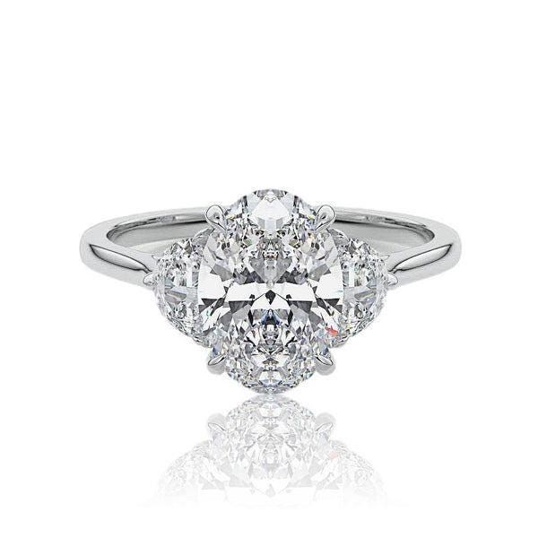 an oval cut engagement ring with three pear shaped diamonds