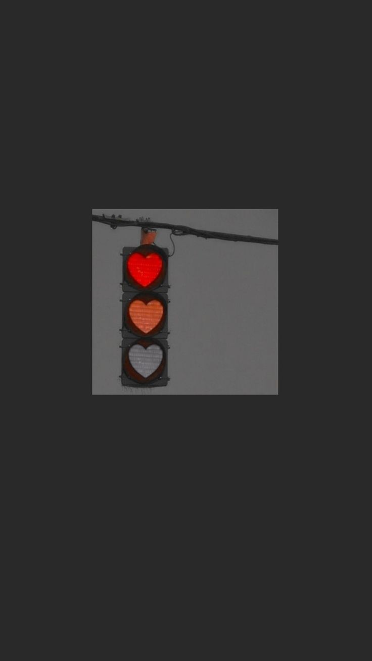 a traffic light with two hearts on it