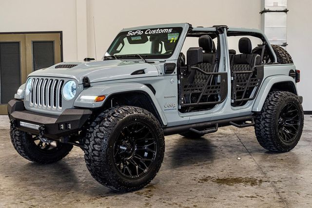 a gray jeep parked inside of a building