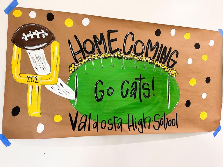 a bulletin board with a football theme and the words home coming go cats valdosta high school