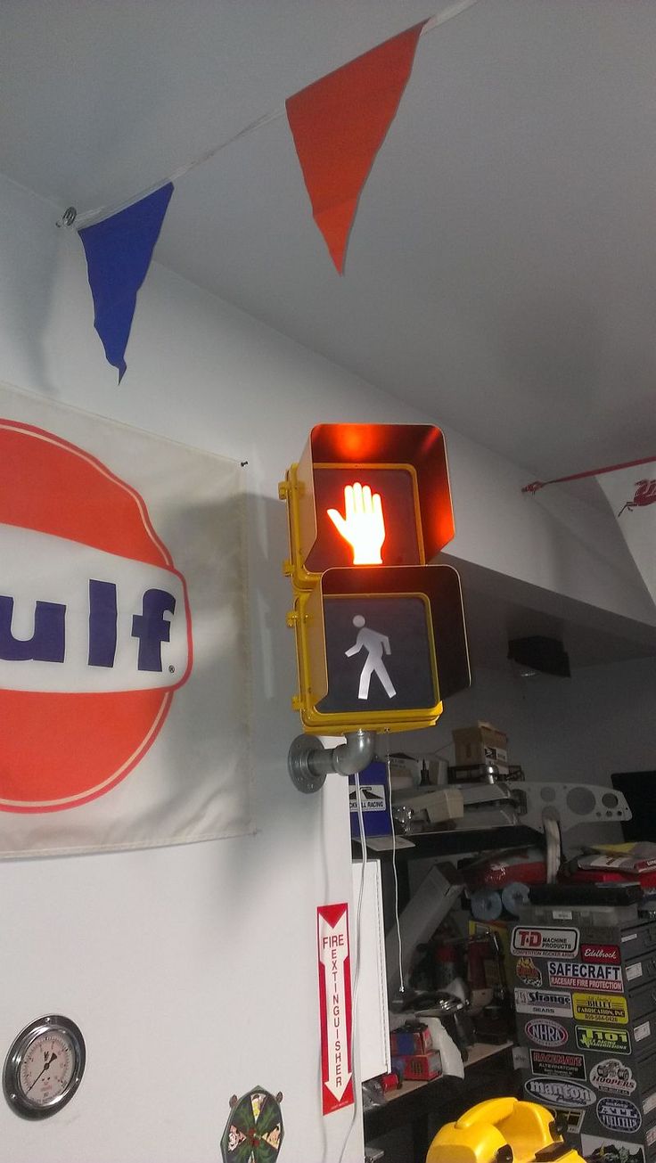 a traffic light hanging from the ceiling next to a sign that says flul on it