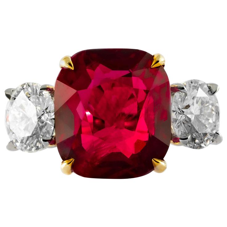 This ruby and diamond 3-stone ring is offered by Shreve, Crump & Low. This cushion cut ruby is custom set in a handcrafted Shreve, Crump & Low classic 3-stone platinum and 18kt yellow gold ring, consisting of 1 extraordinarily saturated red cushion cut ruby weighing 9.13 carats. The ruby center stone is accenting by two GIA Certified round brilliant diamonds 1.04 carats and 1.00 having a color and clarity of E SI1 and D SI1, and a total carat weight of 2.04 carats. The 9.13 carat ruby is from Ma Ruby And Diamond Ring, Ruby Diamond Rings, Platinum Diamond Rings, Ruby Engagement Ring, Diamond Cocktail Rings, Diamond Engagement Ring Set, Ruby Jewelry, Fine Jewels, Platinum Ring