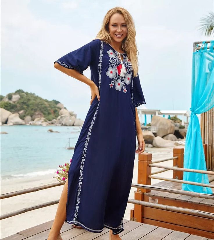 Transport back to the 70s while wearing our Boho Chic Floral Embroidered Kaftan Dress. You will feel like a flower child from 73 in the floral embroidery that decorates the bodice of this kaftan. The clashing colors of navy blue and burnt orange bring a vintage feel to this piece while its stitching and decorative embroidery adds an artistic touch that catches onlooker's attention. Wear this dress with your hair down and bare feet or sandals to connect with the spirit of the peaceful era it is i V-neck Dress With Floral Embroidery For Beach Season, Short Sleeve Embroidered Dresses For Beach Season, Bohemian Floor-length Dress With Resham Embroidery, Folk Style Embroidered Floor-length Dress, Spring Embroidered Beachwear Maxi Dress, Summer Embroidered Dresses For Beach Season, Embroidered Long Maxi Dress For Vacation, Folk Style Floral Print Maxi Dress For Beach, Summer Dresses With Floral Embroidery For Beach Season