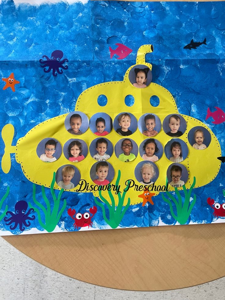 a child's photo collage is displayed on a bulletin board with an underwater theme