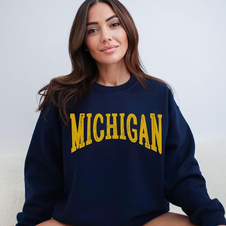 Score major style points with our Michigan Sweatshirt! This spirited design is your ticket to Pure Michigan vibes and college football fervor. Crafted for comfort and Midwestern pride, this sweatshirt lets you wrap yourself in warmth and gridiron spirit - where comfort meets game day excitement! Ideal for any situation, a unisex heavy blend crewneck sweatshirt is pure comfort. These garments are made from polyester and cotton. This combination helps designs come out looking fresh and beautiful. The collar is ribbed knit, so it retains its shape even after washing. There are no itchy side seams on these sweaters.  .: Made with a medium-heavy fabric blend of 50% cotton and 50% polyester (8.0 oz/yd² (271.25 g/m this sweatshirt feels cozy and is the perfect choice for those colder months. .: T Oversized School Spirit Tops For Campus, Collegiate Sweatshirt With University Logo For Game Day, Collegiate Tops With University Logo For Campus, Oversized Collegiate Sweatshirt For College, Varsity Sweatshirt With University Logo For Game Day, Varsity Tops With University Logo For Campus, Oversized Fan Apparel Sweatshirt For College, Oversized College Sweatshirt For Fan Apparel, Collegiate Tops For Sports Season On Campus