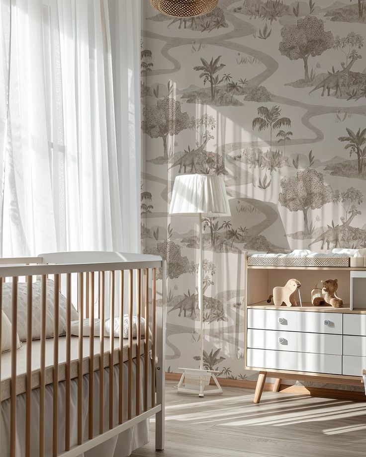 a baby's room with a crib, dresser and wallpaper in neutral tones