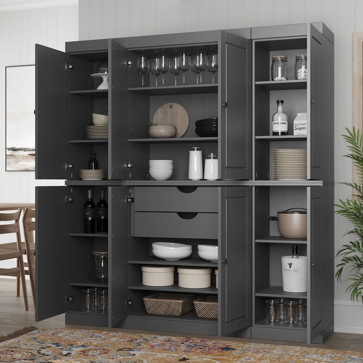 an open cabinet with dishes and glasses on it in a living room or dining room