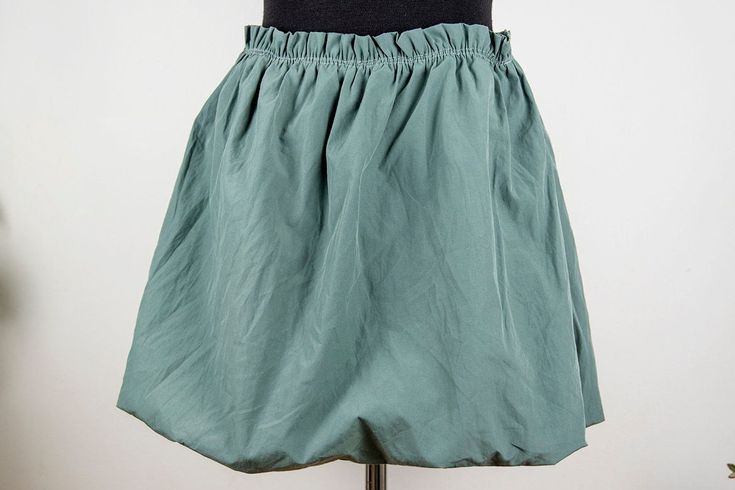 Vintage sage green mini skirt in mint condition. Seems handmade Shell feels cotton polyester blend Lining feels like cotton spandex blend Fits like women size M waist 34 cm = 13.4 inches hips open length 42 cm = 16.5 inches Green Stretch Cotton Skort, Green Cotton Mini Skirt With Elastic Waistband, Green Stretch Short Skirt, Green Mini Length Cotton Skort, Green Mini-length Cotton Skort, Green Mini Cotton Skort, Cotton Mini Skort With Gathered Skirt, Green Mini Length Cotton Bottoms, Green Mini-length Cotton Bottoms