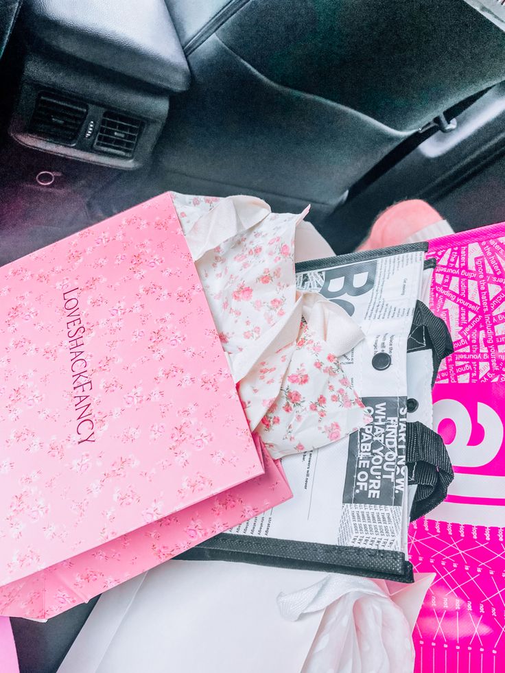 the inside of a car with pink and white items