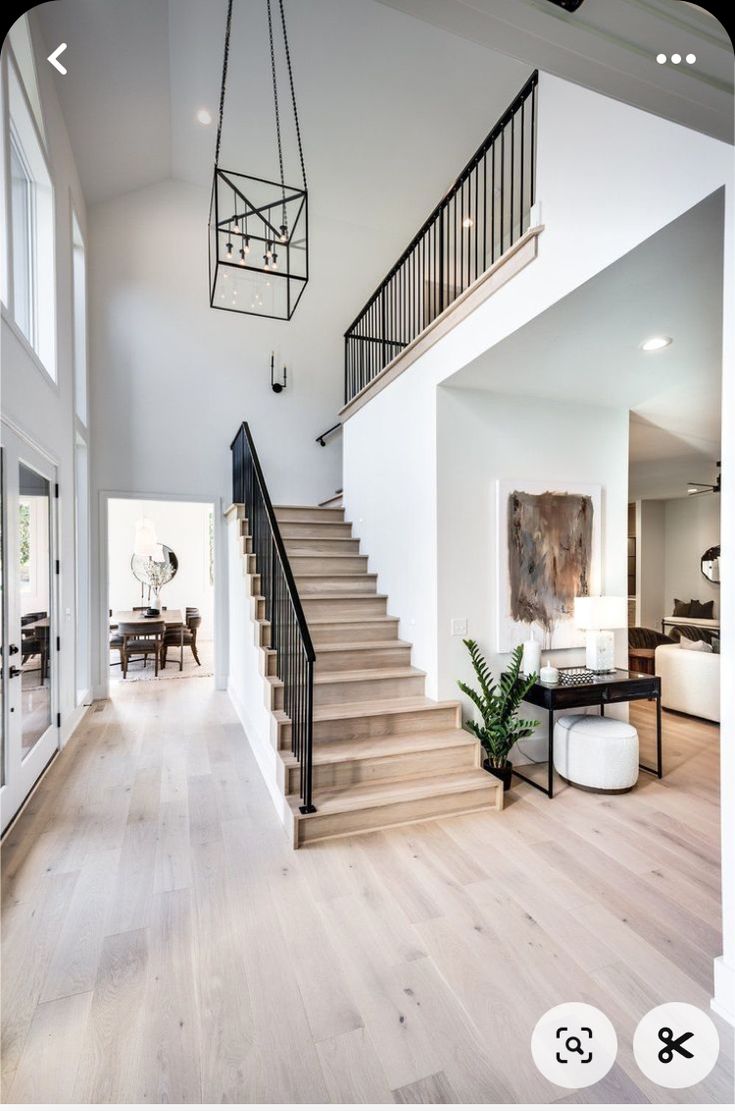 a large open floor plan with stairs leading up to the second story