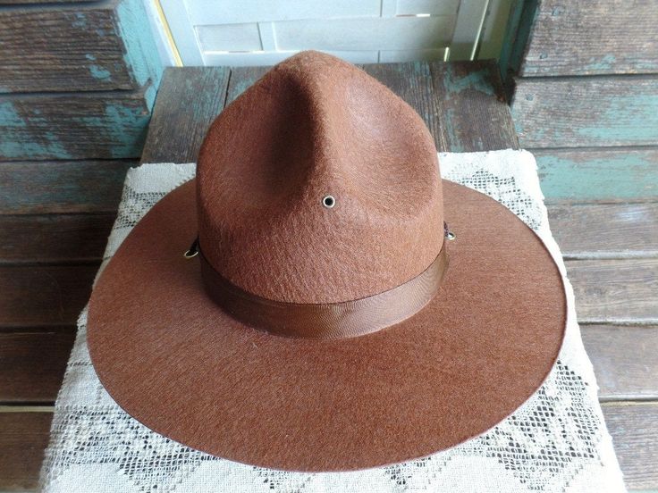 "This listing is for a Vintage Boy Scout Hat. It is made of a felt material and measures approximately 14 3/8\" in diameter. There are no markings or a size listed but the head area measures 7\" in diameter. It is in great condition with the band having a very light water mark on it. The wood head form is not for sale and was used for a prop only. Please ask any questions prior to purchasing. Thanks for looking." Fitted Brown Felt Hat, Brown Brimmed Felt Hat One Size, Fitted Felt Cap For Fall, Vintage Felt Hat With Flat Brim, Brown Felt Hat Bands With Curved Brim, Fitted Fall Felt Cap, Flat Brim Felt Hat For Country Events, Vintage Fedora Felt Hat, Wide Brim Felt Hat For Country Events