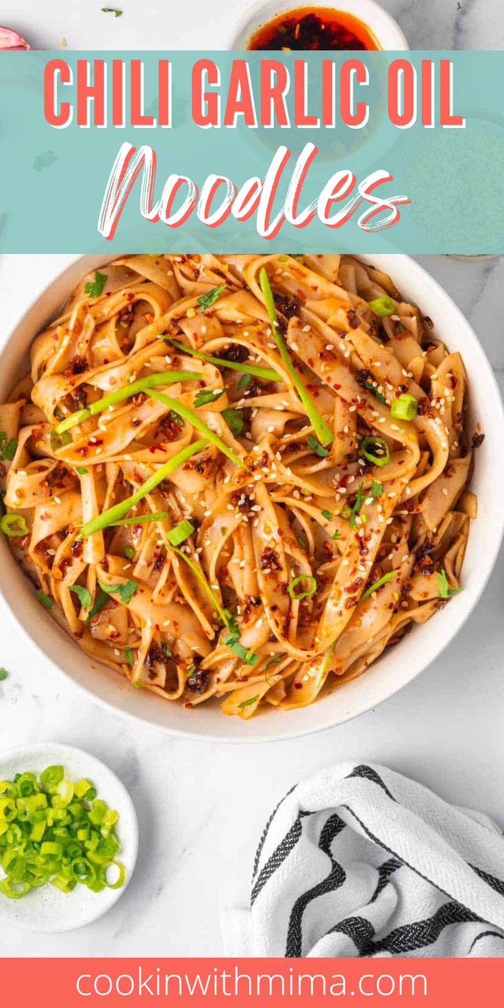 a bowl filled with chili garlic noodles and garnished with scallions on the side