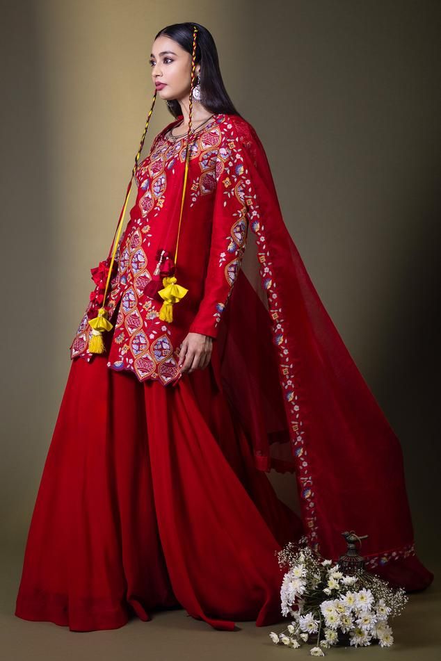 Red kurta with all over floral Mughal pattern and multi color thread embroidery. Paired with flared sharara and embroidered bordered dupatta.
Components: 3
Pattern: Embroidered
Type Of Work: Thread Work
Neckline: Leaf Neck
Sleeve Type: Full Sleeves
Fabric: Raw Silk, Georgette, Organza
Color: Red
Other Details: 
Cut work hem details
Kurta Closure: Front concealed zip
Note: The hair accessory worn by the model is not for sale
Occasion: Wedding,Sangeet - Aza Fashions Mughal Pattern, Flared Sharara, Kurta Sharara Set, Red Kurta, Kurta Sharara, Short Kurta, Sharara Set, Thread Embroidery, Embroidered Shorts