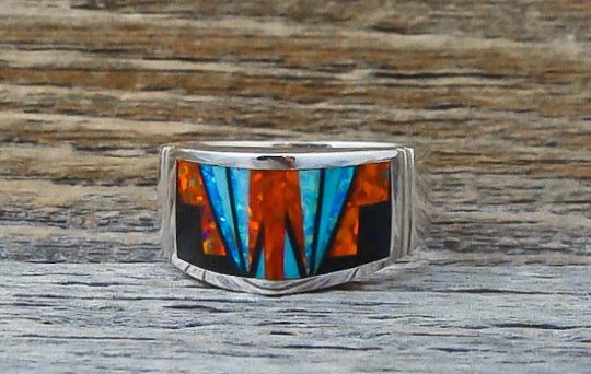 This band ring is handcrafted with Sterling Silver and beautifully inlaid with bright , dazzling, Fire Lab Opal and Onyx. As is seen in this work of art, the artist's talent is evident! It is a favorite due to the expertly clean cut geometric work, followed by the angular shape of the ring. This is that signature accessory that will compliment your wardrobe. We are proud to offer the David Rosales Collection of fine Native American Indian Jewelry. He has built a reputation for the finest inlaid Multicolor Inlay Rings For Anniversary, Anniversary Multicolor Inlay Rings, Unique Multicolor Rings With Polished Finish, Artisan Rings With Inlay For Anniversary, Southwestern Style Rings With Inlay As Gift, Southwestern Style Rings With Inlay For Gift, Multicolor Inlaid Ring Jewelry, Multicolor Inlay Ring Jewelry, Artisan Multicolor Rings With Inlay