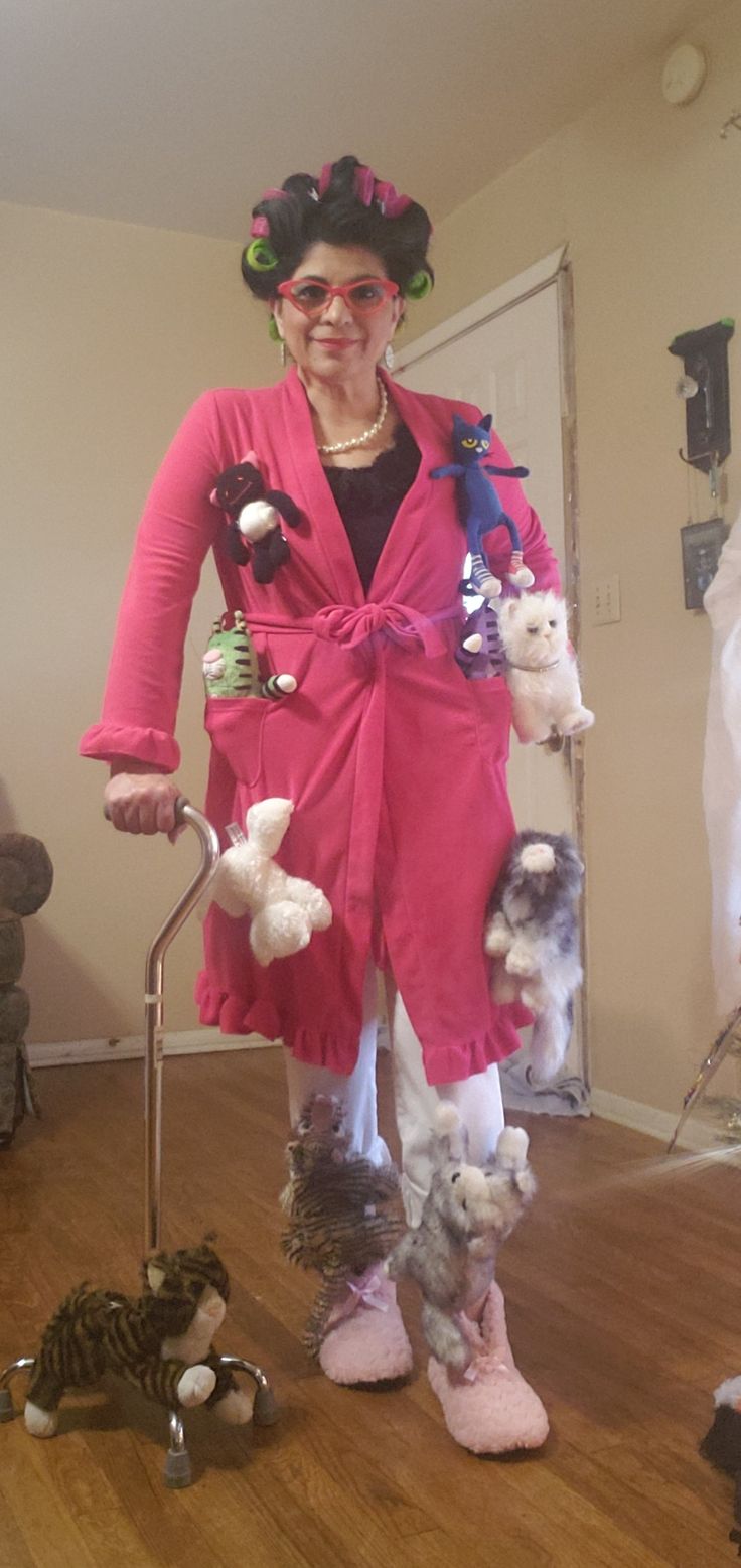 a woman in pink is standing on the floor with stuffed animals