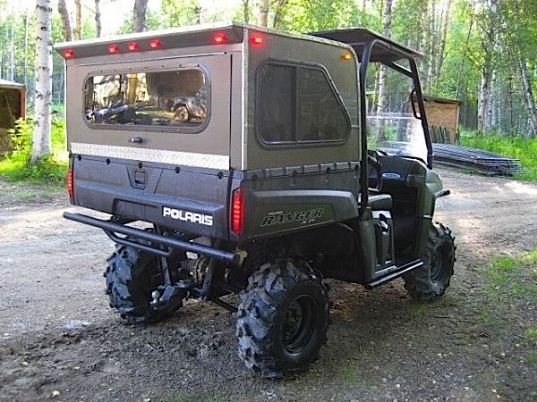 an off road vehicle parked in the woods