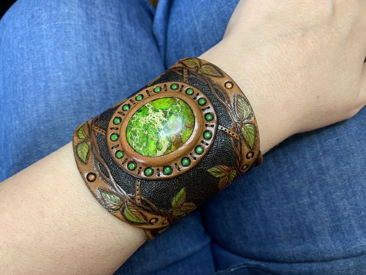 "\"Meliae\" a tooled leather bracelet with bright green sea sediment jasper cabochon and colorful leaves. It reminds me about old times of witches, dryads, druids, elves, fairies and other creatures who lived in harmony with Mother Earth. The cuff was made to fit a 7\" wrist. 👆 NB❗️❗��️❗️I HIGHLY recommend choosing PAYPAL payment option! Items paid by any method other than PayPal will take longer to become available, for all other options are slower. I also have to note that I'm not responsible f Hand Tooled Leather, Green Sea, Leather Cuffs Bracelet, Paypal Payment, Fantasy Jewelry, Tooled Leather, Colorful Leaves, Leaf Pendant, Handmade Artisan