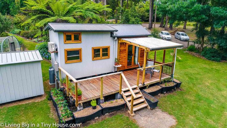 the tiny house is built on stilts and has stairs leading up to it's second floor