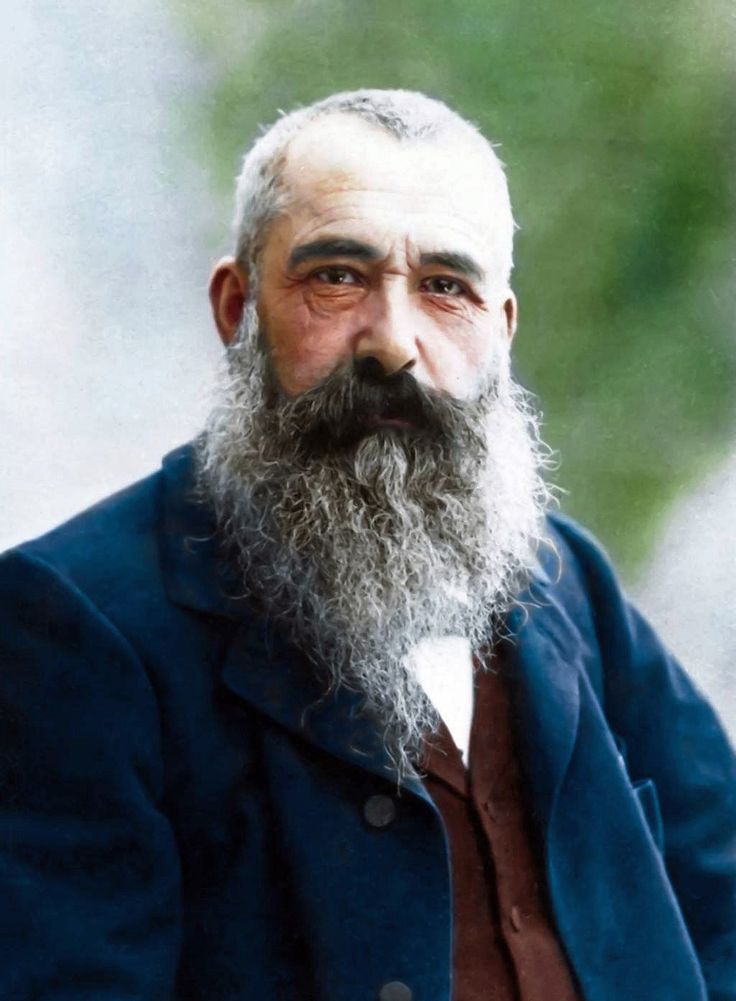 an old photo of a man with a long beard and wearing a blue suit jacket