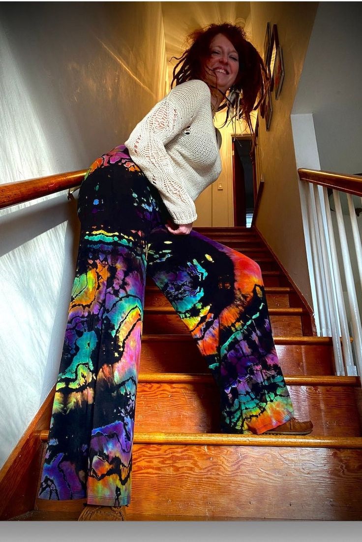 Reverse Rainbow Dyed Palazzo pants that have a fold down yoga band and come in sizes XS-5X. These pants have been reverse dyed to remove color then carefully hand dyed using low impact dyes. These pants feature a lightweight fabric with great stretch for comfort and have double stitching on bottom hem to withstand time. These pants are unlined. 95% RAYON 5% SPANDEX We would like to note that they are pre-shrunk CARE All leggings are hand dyed by me, machine washed and dried many times in all wat Rainbow Pants, Yoga Band, Gaucho Pants, Tie Dye Pants, Festival Pants, Rainbow Tie Dye, Beautiful Kimonos, Rainbow Tie, Custom Leggings