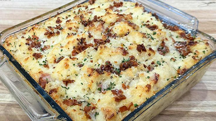 a casserole dish with meat and cheese in it on a wooden table top