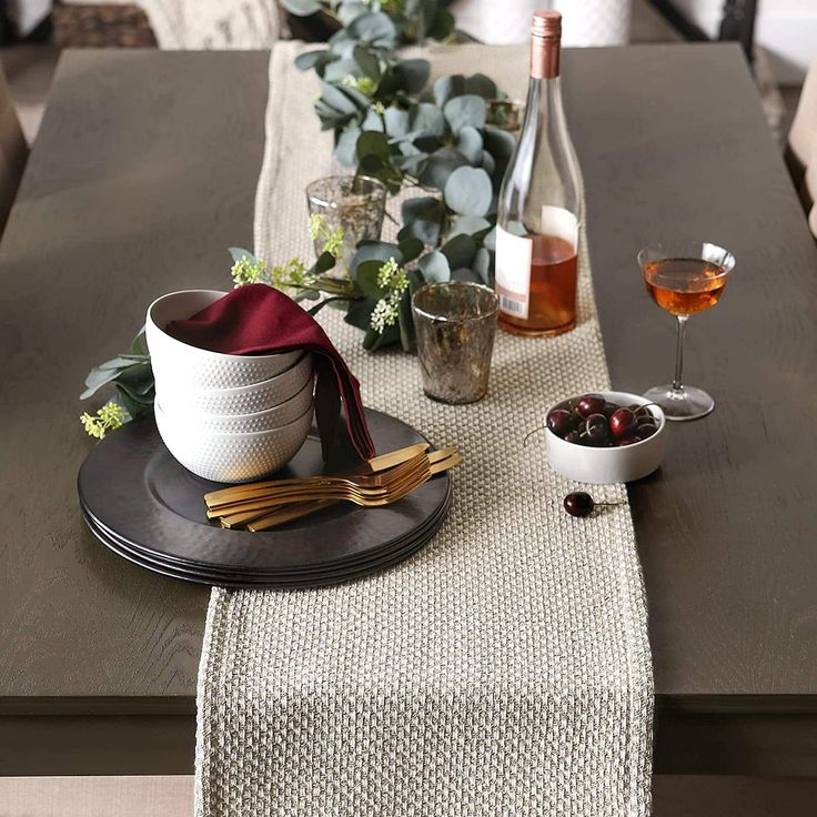 the table is set with plates, bowls and glasses