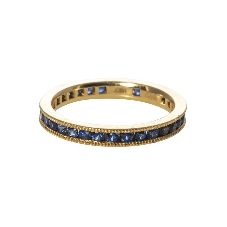 This eternity band features round blue sapphires channel-set in 18K yellow gold with milgrain edges. Total blue sapphire weight: 1.0ct Ring size: 6 Gold Eternity Band, Circle Monogram, Channel Set, Eternity Band, Hand Engraving, Eternity Bands, Blue Sapphire, Stone Color, Gold Bracelet