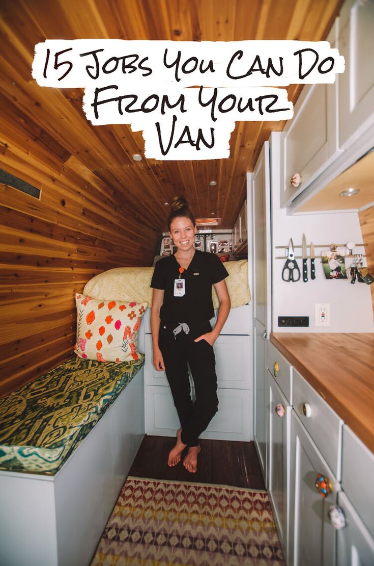 a woman sitting on top of a bed in a room with wooden walls and flooring