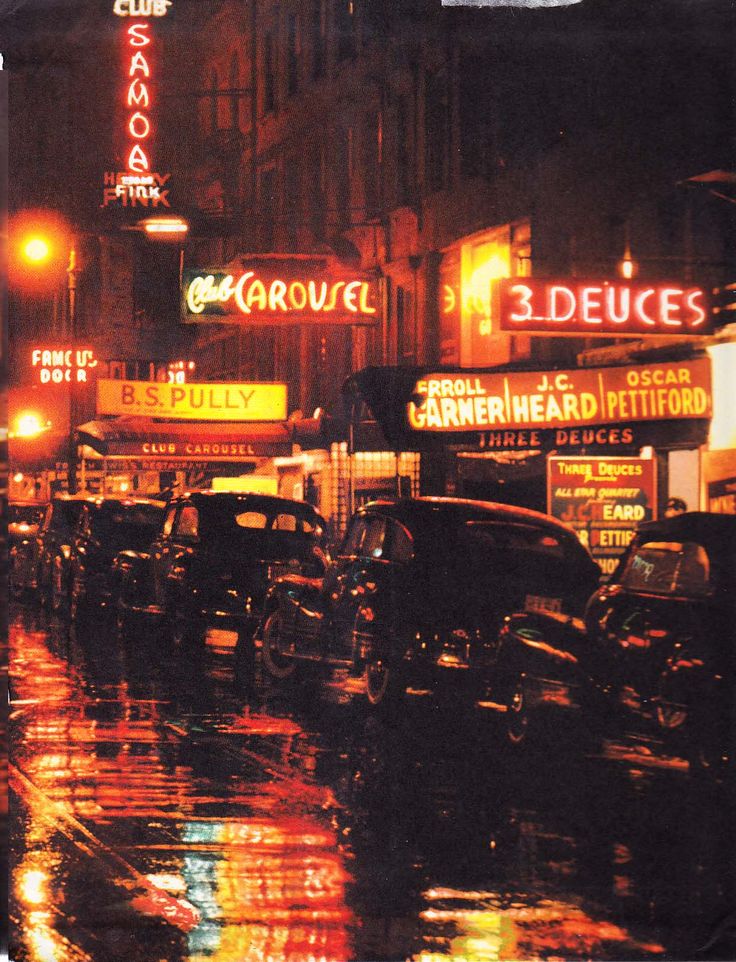 a city street filled with lots of traffic on a rainy night in the rain at night