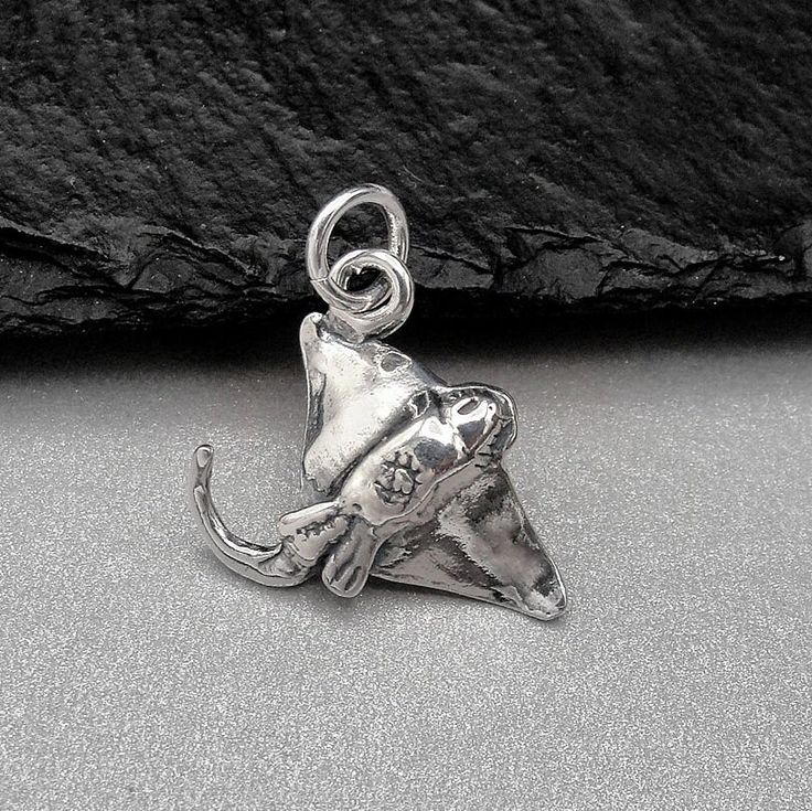 This Stingray Charm comes with a silver jump-ring as pictured. Please note that photo is not to scale and may appear larger to show detail. Refer to exact measurements below. Additional attachments (lobster clasp, large-hole bead, necklace chains) are available from the charm-attachments drop-down menu.  For a visual example of the different attachments and what each one is best suited for, scroll through the photos until you see the example photo or visit https://etsy.me/2BY7DAW for detailed in Sterling Silver Gray Dangle Jewelry, Gray Sterling Silver Dangle Jewelry, Adjustable Gray Sterling Silver Jewelry, Unique Gray Jewelry As Gift, Unique Gray Jewelry For Gifts, Unique Gray Jewelry For Gift, Ocean Gifts, Pandora Beads, Manta Ray