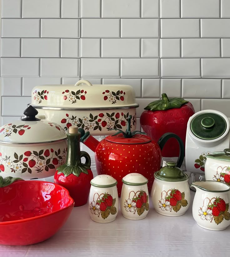 a table topped with lots of red and white dishes