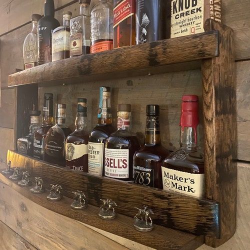 a wooden shelf filled with bottles and glasses