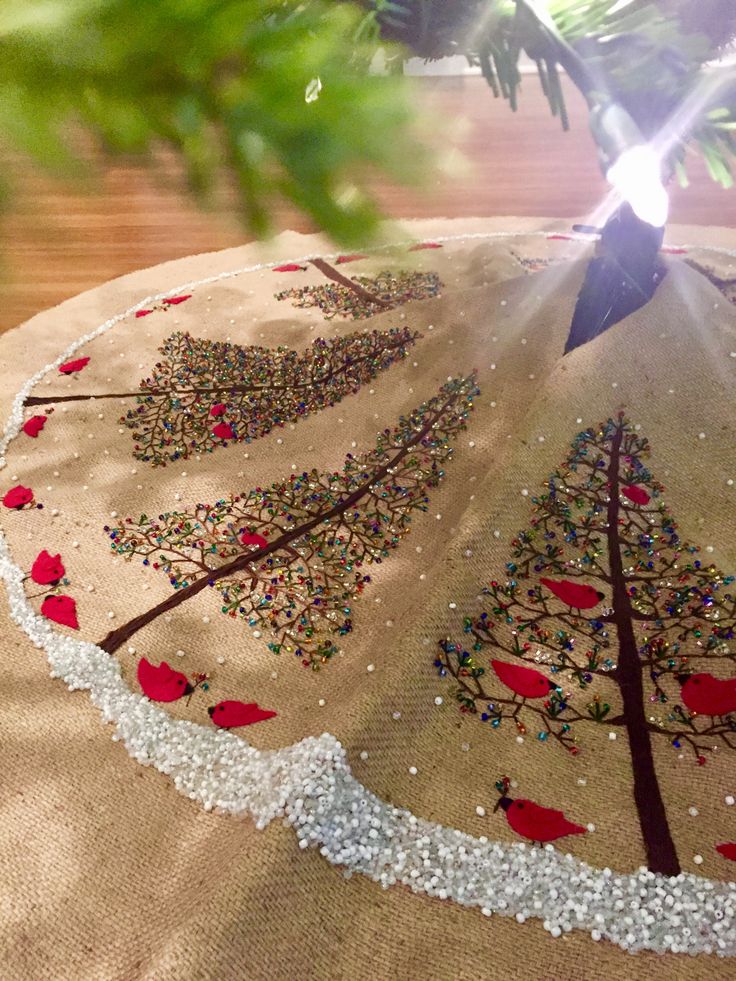 a christmas tree skirt is hanging on a table