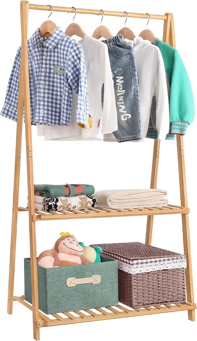 a wooden rack with clothes and other items on it, against a white background that is also used as a shelf for clothing