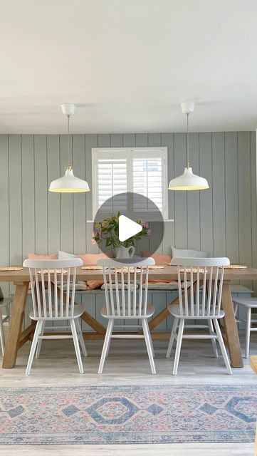 a dining room table with chairs and a rug on the floor in front of it