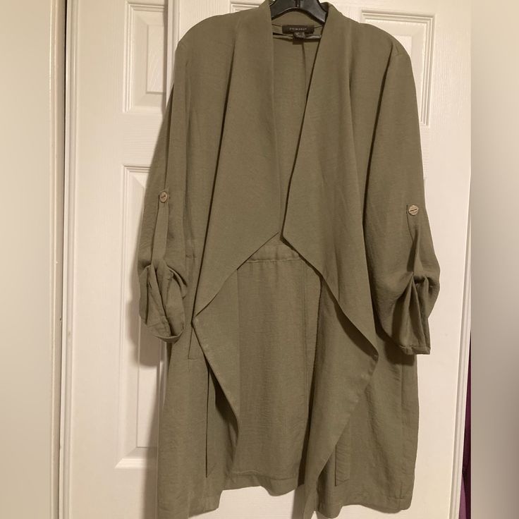 Olive Green Or Sage Color Kimono Style Jacket Never Worn Can Be Worn As A Jacket Or Shirt Or As Tht Knock On The Door I’m Here Type Iykyk Khaki Long Sleeve Blazer For Spring, Long Sleeve Khaki Outerwear For Layering, Khaki Long Sleeve Outerwear For Layering, Casual Khaki Cardigan For Spring, Casual Open Front Blazer For Work, Khaki Long Sleeve Cardigan For Work, Trendy Outerwear With Pockets For Daywear, Spring Open Front Outerwear For Day Out, Green Open Front Outerwear For Spring