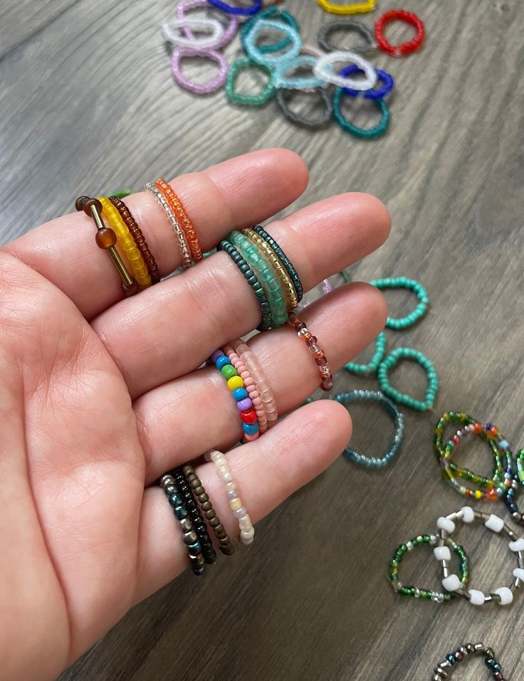 "Summer is coming up, which means cute and colorful jewelry is going to be every outfits best friend! Seed bead rings are super cute and can really go a long way when styling. These are made with elastic and are stretchy, so they will fit everyone even if you are unsure of your ring size.  Each order comes with a set of 5 beaded rings, so make sure you put what color(s) you would like! I offer every color, so if there is a specific color palette or just one color for all, please let me know so t Rainbow Spacer Beads Jewelry As A Gift, Unique Colorful Beads Jewelry For Friendship, Unique Colorful Beaded Jewelry For Friendship, Handmade Minimalist Rainbow Jewelry, Trendy Rainbow Jewelry With Tiny Beads, Adjustable Rainbow Stackable Jewelry, Multicolor Stackable Round Beads Jewelry, Everyday Multicolor Jewelry With Tiny Beads, Everyday Multicolor Beaded Jewelry