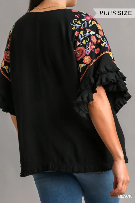 Step up your fashion game with our Floral Embroidered Round Neck Top! Crafted from a luxurious blend of 55% linen and 45% cotton, this top offers both comfort and style. The full front and back of this gorgeous top is a lovely solid go with anything black which provides a chic backdrop for the vibrant, multi-colored embroidery on the sleeves. The unfinished frayed hem adds a trendy, casual touch. Perfect for any occasion, this top is sure to become a staple in your wardrobe. Models are wearing s Short Sleeve Linen Tops With Floral Embroidery, Linen Tops With Floral Embroidery And Short Sleeves, Short Sleeve Linen Top With Floral Embroidery, Casual Linen Tops With Floral Embroidery, Casual Embroidered Linen Tops, Casual Embroidered Linen Blouse, Chic Embroidered Cotton Tops, Embroidered Linen Tops For Spring, Casual Linen Blouse With Floral Embroidery