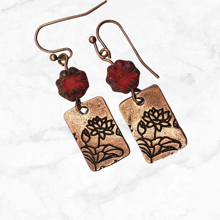 A best seller, these dangle earrings feature a copper charm stamped on both sides and topped with deep red Czech glass flower beads. Handmade and lightweight, they are the perfect go-to red earrings.  Artisan glass beads produced in small quantities in Czech Republic  Hypoallergenic ear wires (nickel and lead free). Choose your ear wire style at checkout. A gift for you or someone special, earrings are carded and in an organza bag. Link back to my shop: https://www.etsy.com/shop/JezaJewelry Flow Czech Earrings, Red Earrings Dangle, Special Earrings, Cottagecore Jewelry, Flower Dangle Earrings, Dangle Earrings Boho, Reno Nv, Red Boho, Copper Red