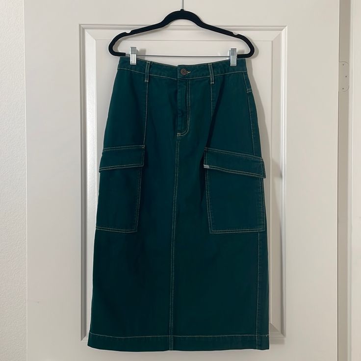 Color: Beautiful Dark Teal Color Cream Contrast Stitching Style: Utility Skirt High Rise 2 Big Cargo Pockets In Front 2 Regular Pockets In Back Maxi Length Condition: Like New Without Tags Brand: Bdg Size: M Blue High Waist Cotton Cargo Skirt, Green Midi Skirt With Pockets, Green High-waist Cargo Skirt With Pockets, High Waist Green Cargo Skirt With Pockets, Green Denim Skirt With Pockets For Spring, Spring Green Denim Skirt With Pockets, Green Pencil Skirt With Pockets, High Waist Green Cotton Skirt, High Waist Green Cotton Cargo Skirt